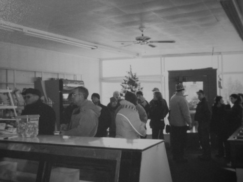 Customers lined up at the counter of Becco's Market at Christmas time