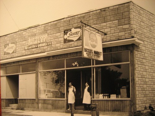 Frank and Tom Becco standing in the doorway of Becco's Market in Iron Mountain, 1989